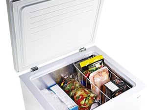Koolatron white chest freezer, open and filled with frozen foods, on a white background