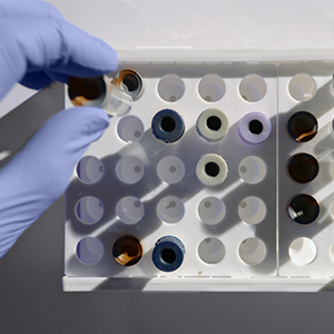 researcher hand on test tubs