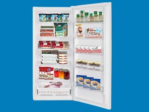 Kenmore convertible upright freezer refrigerator, open and filled with food, on a blue background