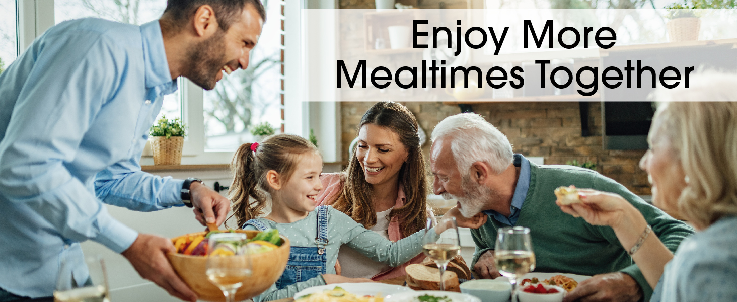 Happy family sharing a meal together; grandparents, parents and child