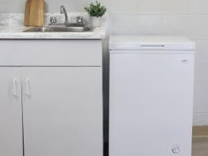 Koolatron white chest freezer, closed, set up beside a white kitchen counter and sink