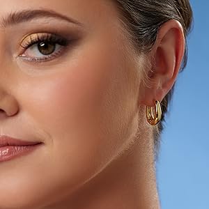Model wearing medium huggie hoops