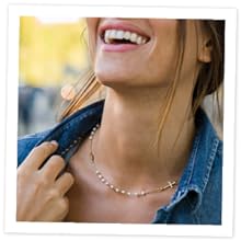 Women wearing 18k gold plated sterling silver necklace with pearls, cross and miraculous medal