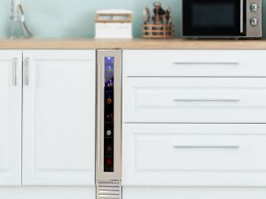 6 inch wide front-venting wine fridge installed in a classic white kitchen