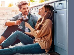 Picture of two people holding glasses of red wine