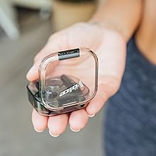Hand holding earbud case