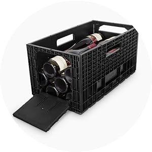 Open black weinbox with many bottles laying flat.